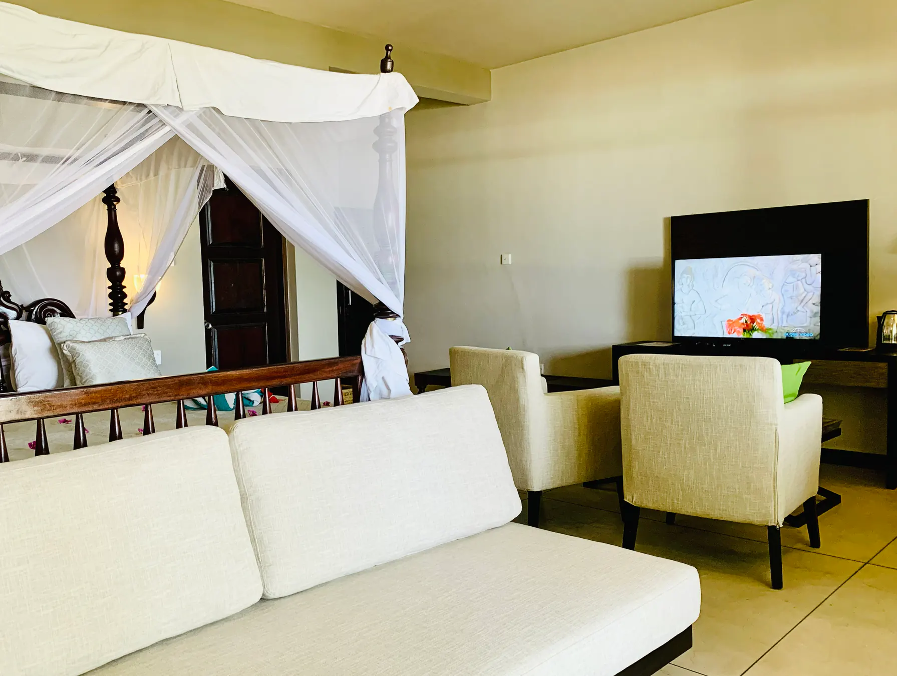 Deluxe Double bedroom, sofa and television area